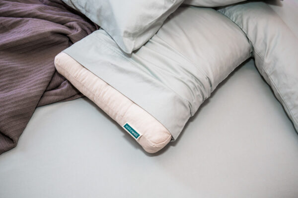 WakeWell Pillow on bed