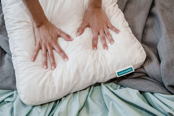 Hands pressing WakeWell Pillow